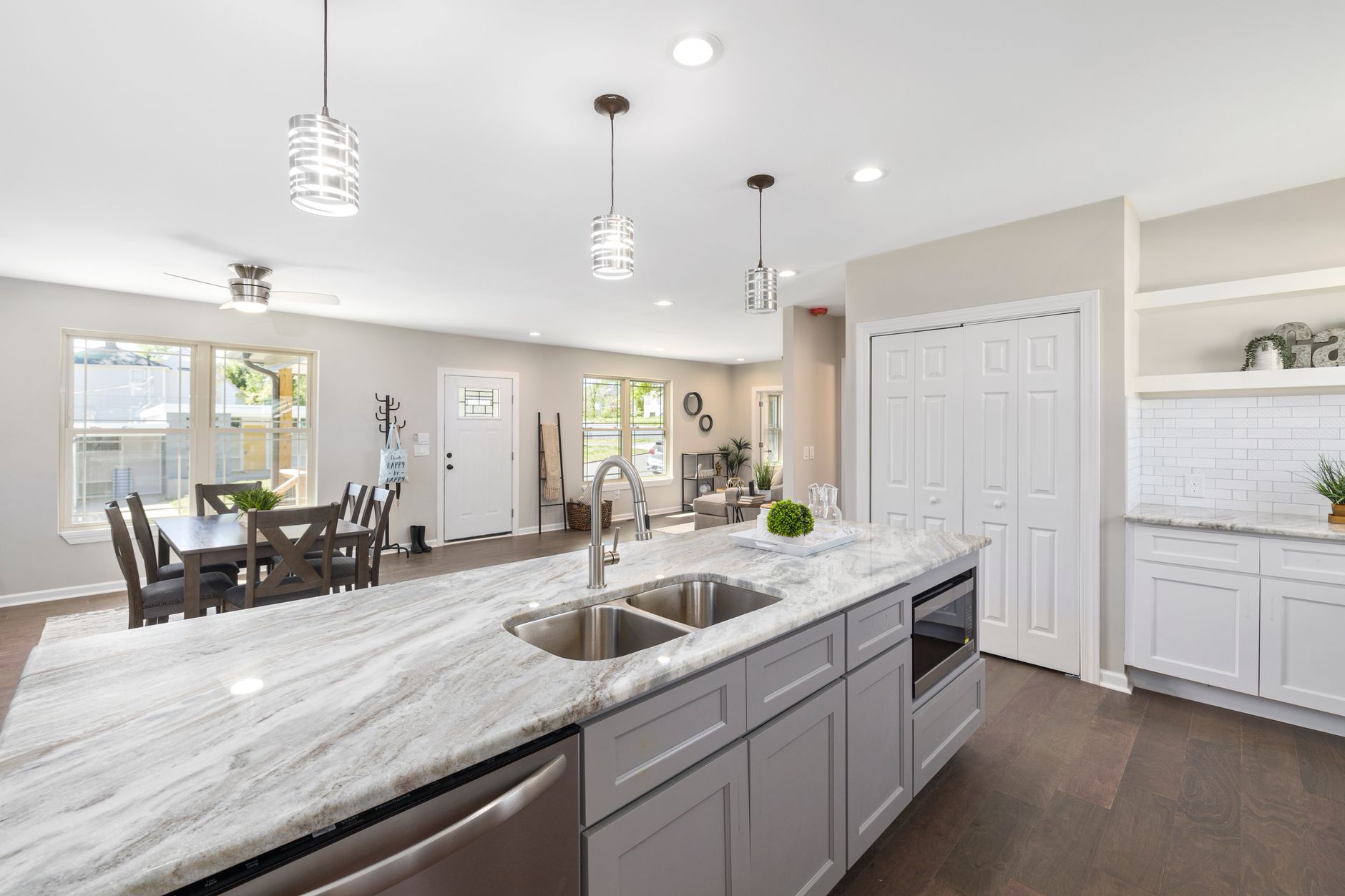 Bright modern kitchen with marble countertop and dining area in Austin, TX